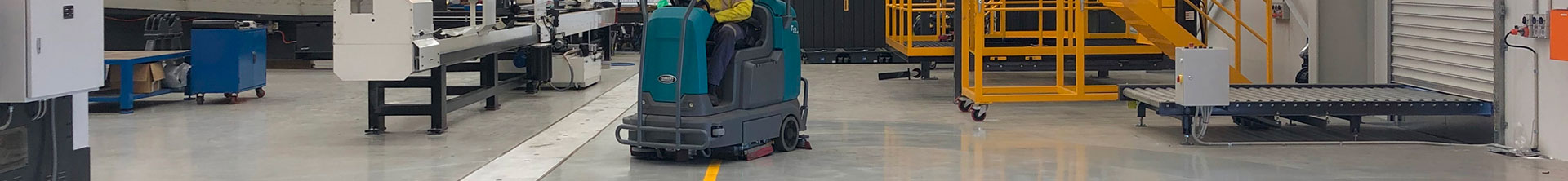 T12 Ride-On Scrubber cleaning a manufacturing facility