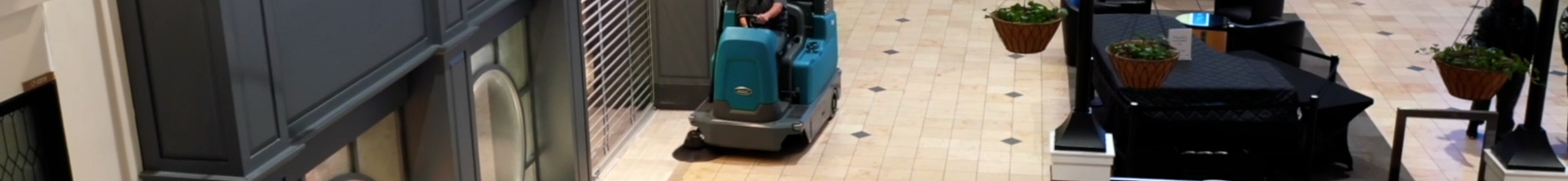 Tennant S16 Ride-On Sweeper cleaning in an airport
