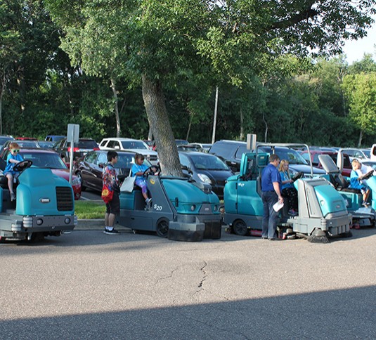 Children sitting on Tennant M17 sweeper-scrubber and S20 sweeper Children sitting on Tennant M17 sweeper-scrubber and S20 sweeper