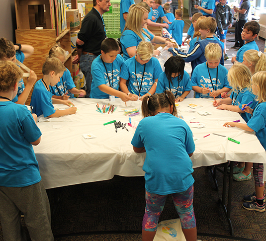 Children making snack packs at Tennant Kids Day Children making snack packs at Tennant Kids Day