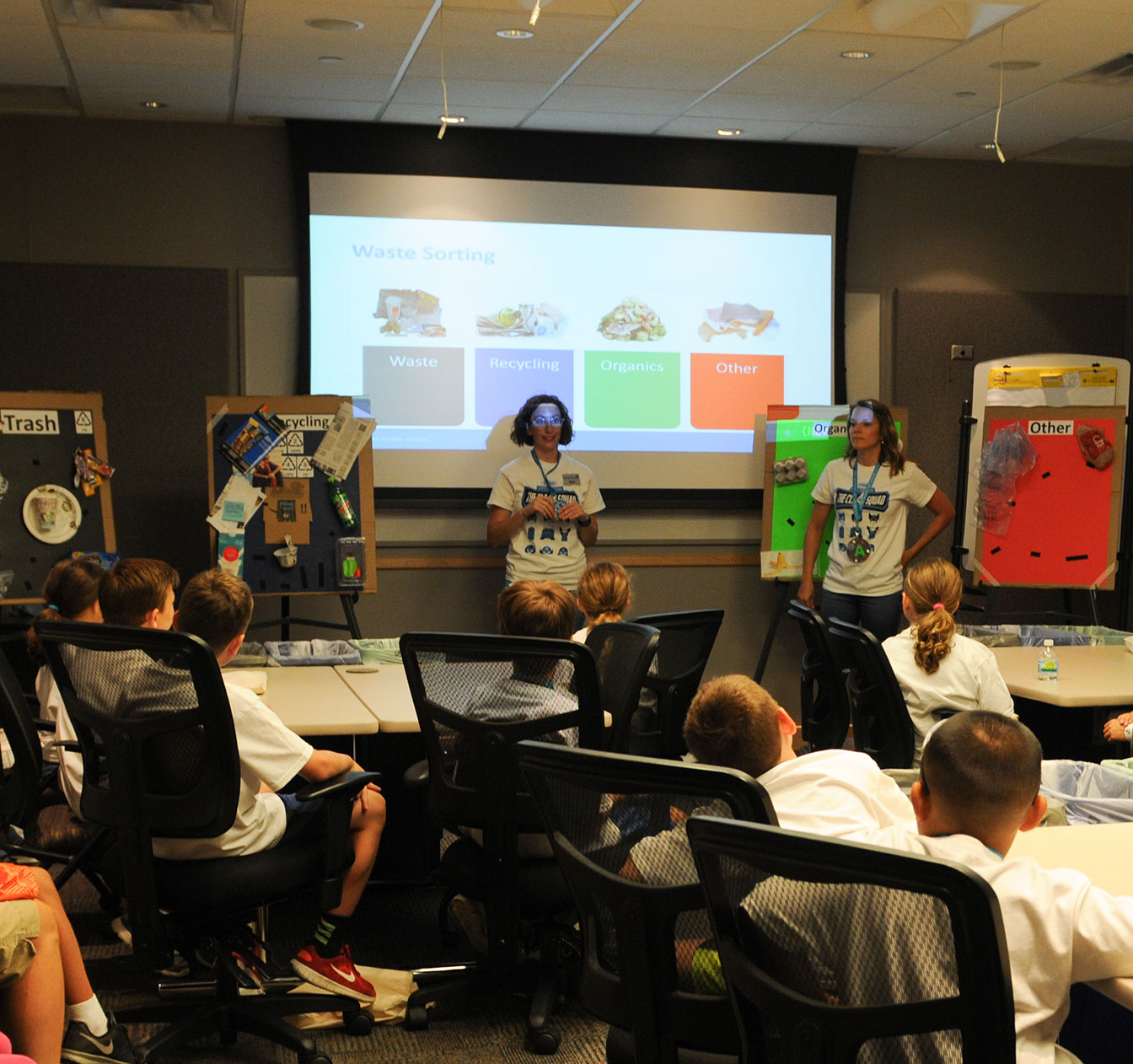 A Tennant employee discusses proper garbage sorting with Kids Day participants A Tennant employee discusses proper garbage sorting with Kids Day participants