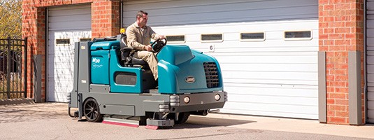 M30 Ride-On Sweeper Scrubber cleaning outdoors M30 Ride-On Sweeper Scrubber cleaning outdoors