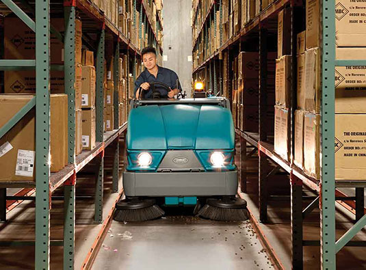 S20 Compact Mid-Sized Rider Sweeper in a warehouse.