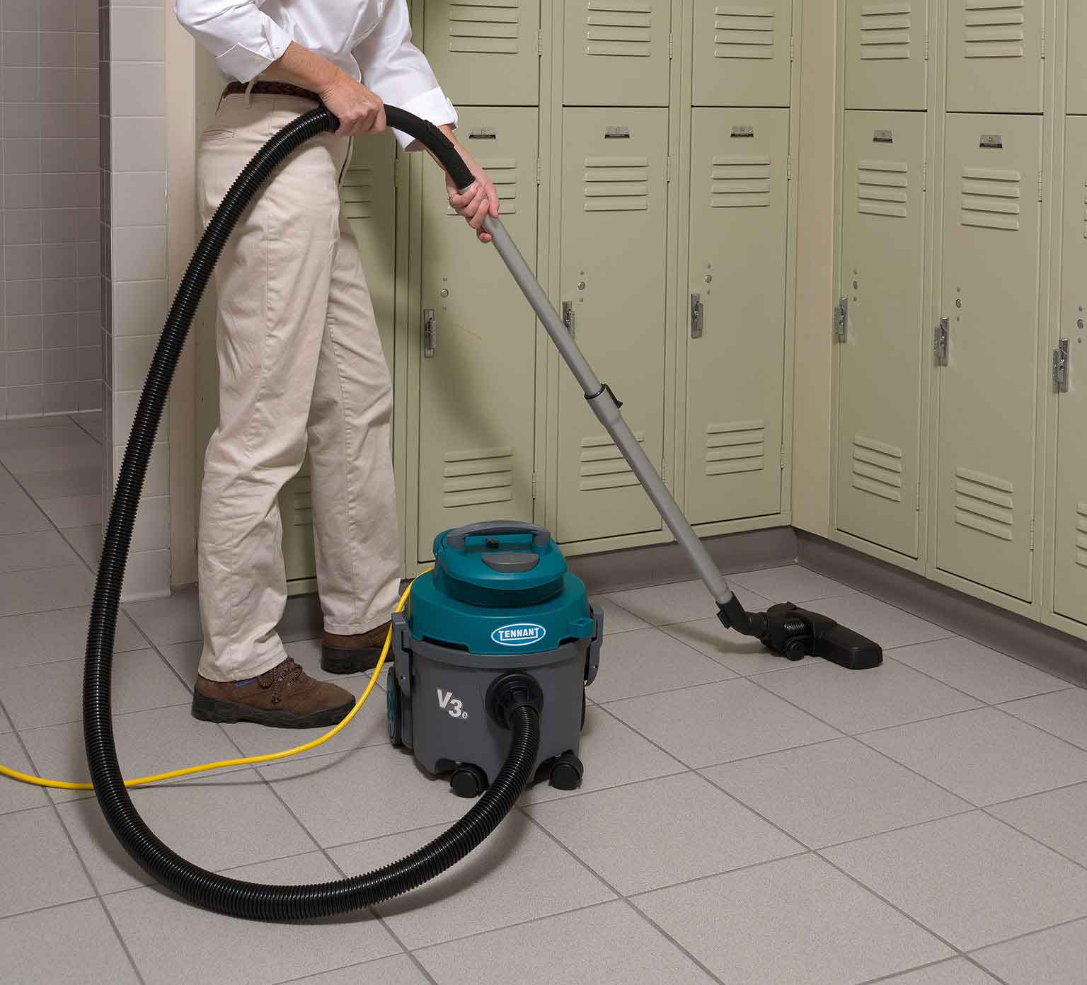 V3e Dry Canister Vacuum cleaning a locker room.