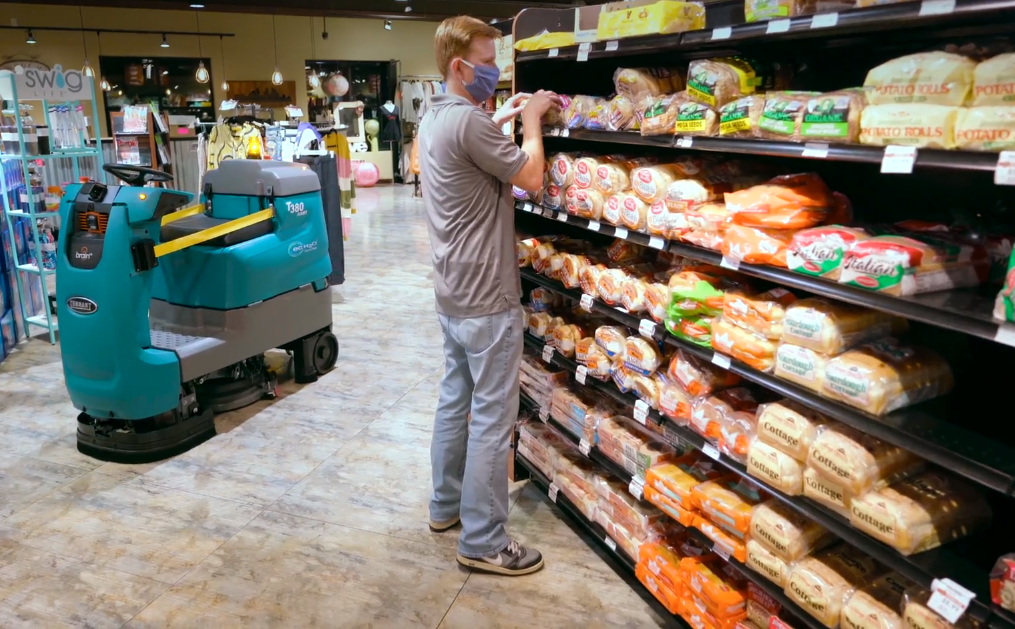 Tennant T380AMR Robotic Floor Scrubber cleaning in a small grocery store allowing for staff to be more productive Tennant T380AMR Robotic Floor Scrubber cleaning in a small grocery store allowing for staff to be more productive
