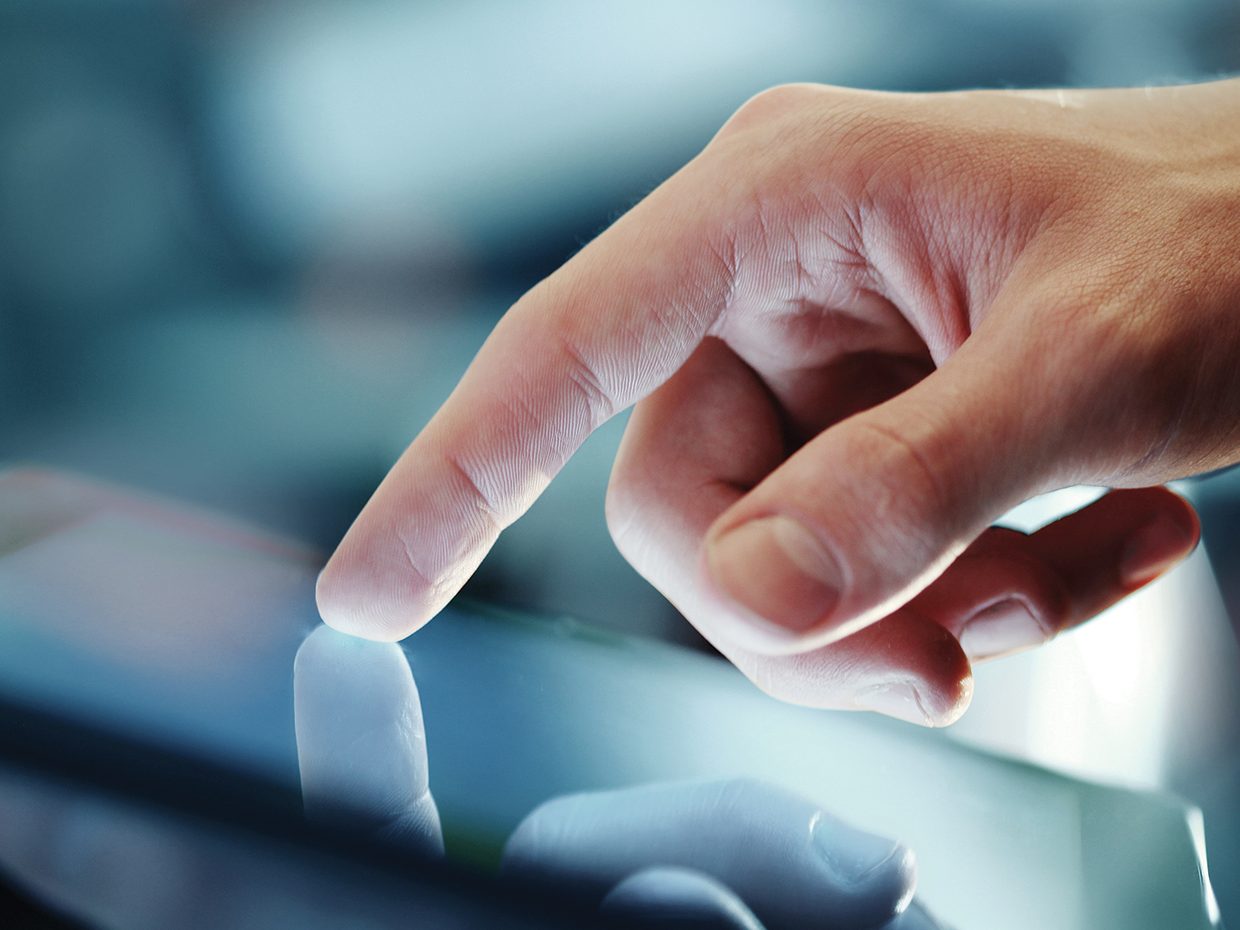 Business person working on digital device Business person working on digital device