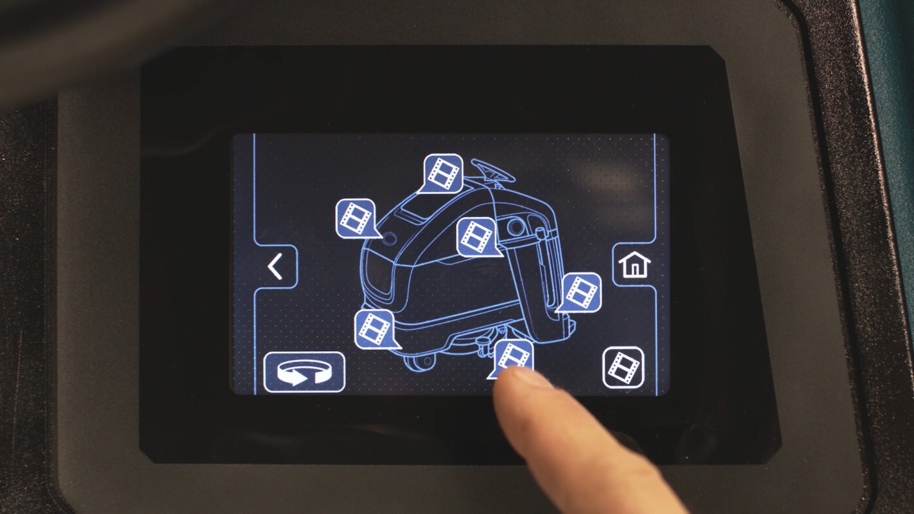 An employee chooses a training topic from an on demand library on a control panel. An employee chooses a training topic from an on demand library on a control panel.