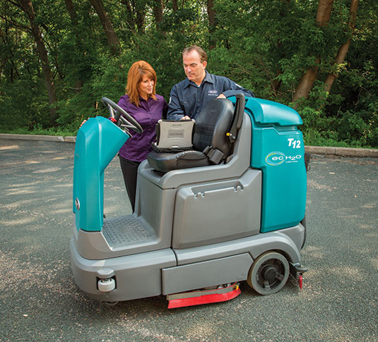 Tennant Service Representative with customer and T12 Ride-On Scrubber Tennant Service Representative with customer and T12 Ride-On Scrubber