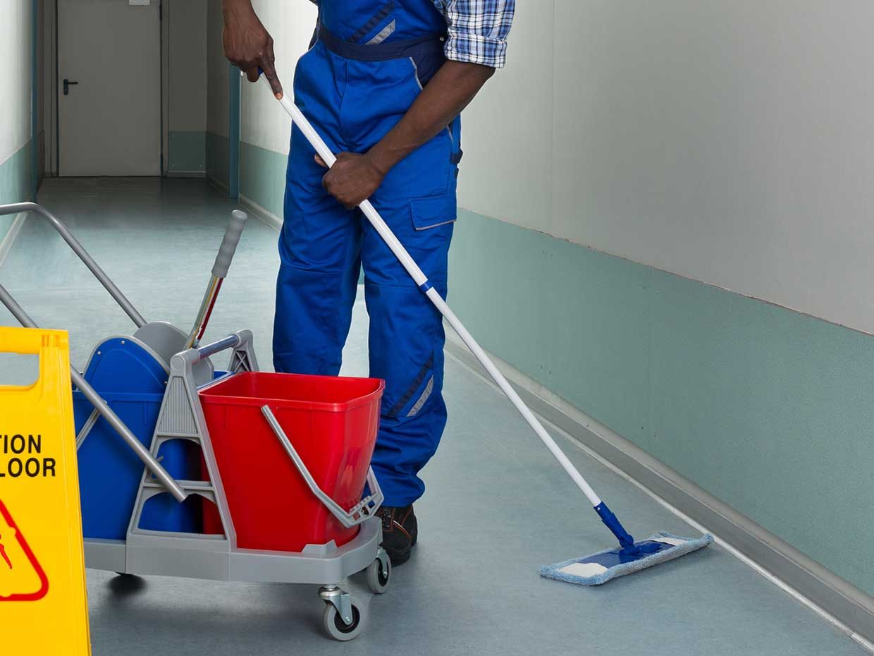 Janitor using microfiber flat mop system Janitor using microfiber flat mop system