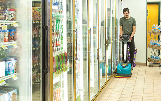 Tennant Company CS5 walk behind floor scrubber cleaning retail convenience store