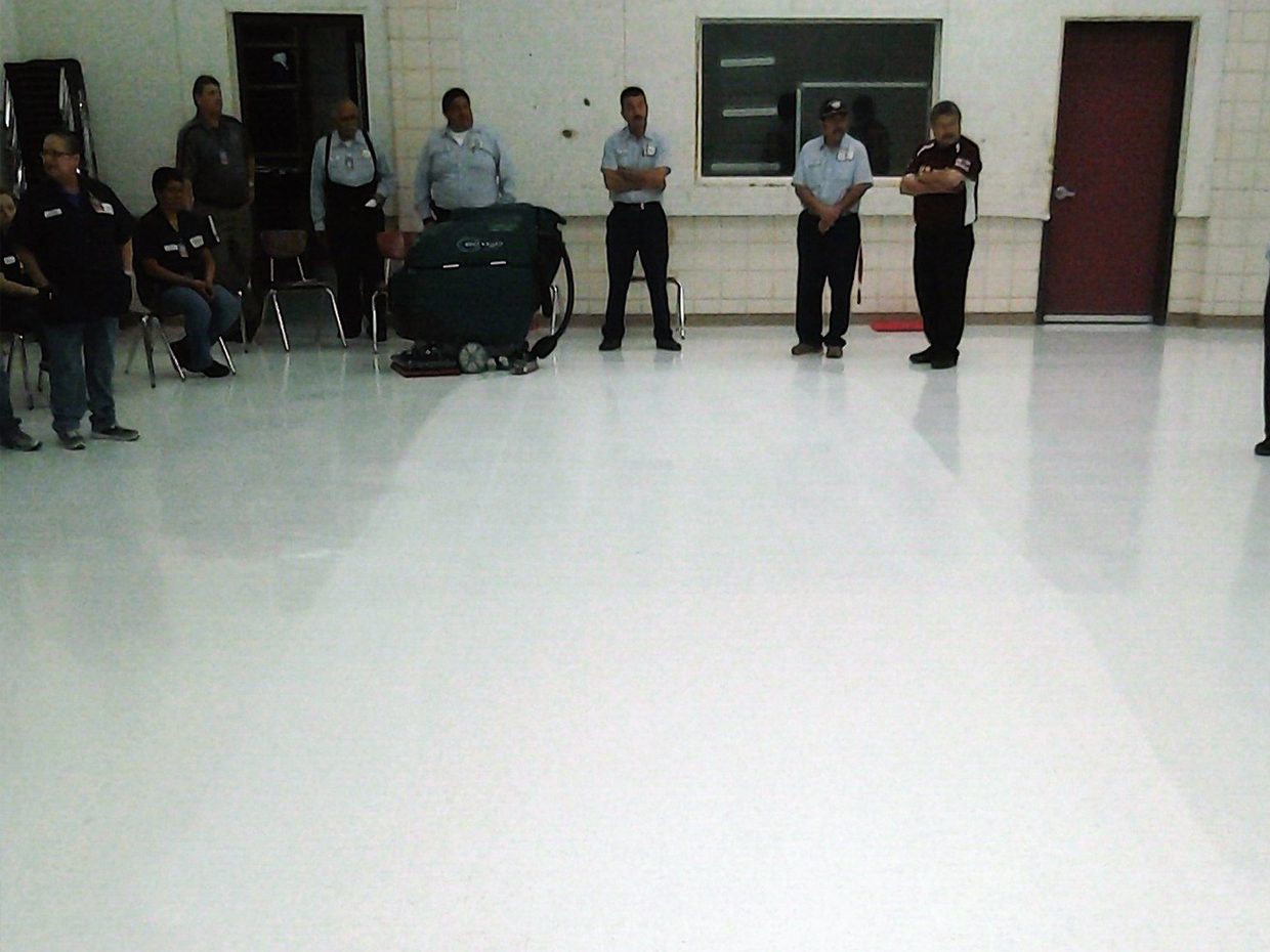 Custodial workers clean floor Custodial workers clean floor