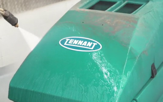 Reconditioned Tennant floor scrubber being washed. Reconditioned Tennant floor scrubber being washed.