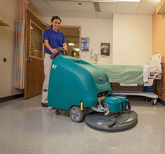 Custodian using the B7 Battery Burnisher in a hospital room. Custodian using the B7 Battery Burnisher in a hospital room.