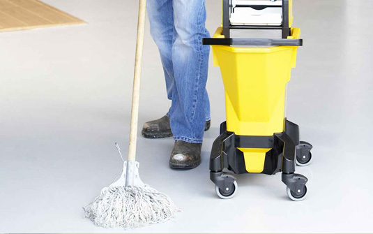 custodial staff using old fashion mop and bucket to clean custodial staff using old fashion mop and bucket to clean