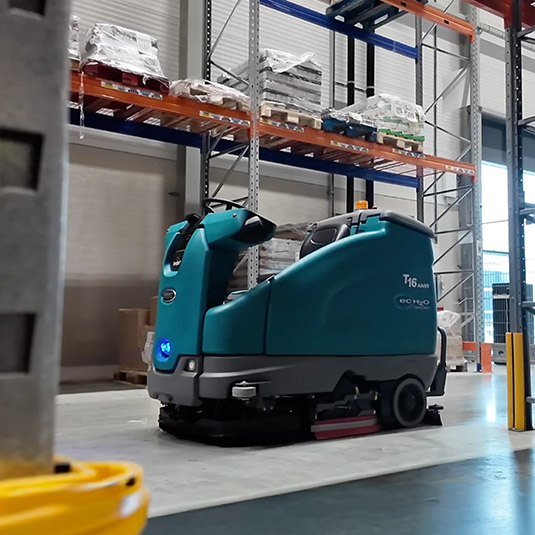 Tennant cleaning machine in a warehouse