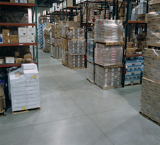 A warehouse aisle. Keeping aisles clean and free of clutter contributes to efficient warehouse operations. A warehouse aisle. Keeping aisles clean and free of clutter contributes to efficient warehouse operations.