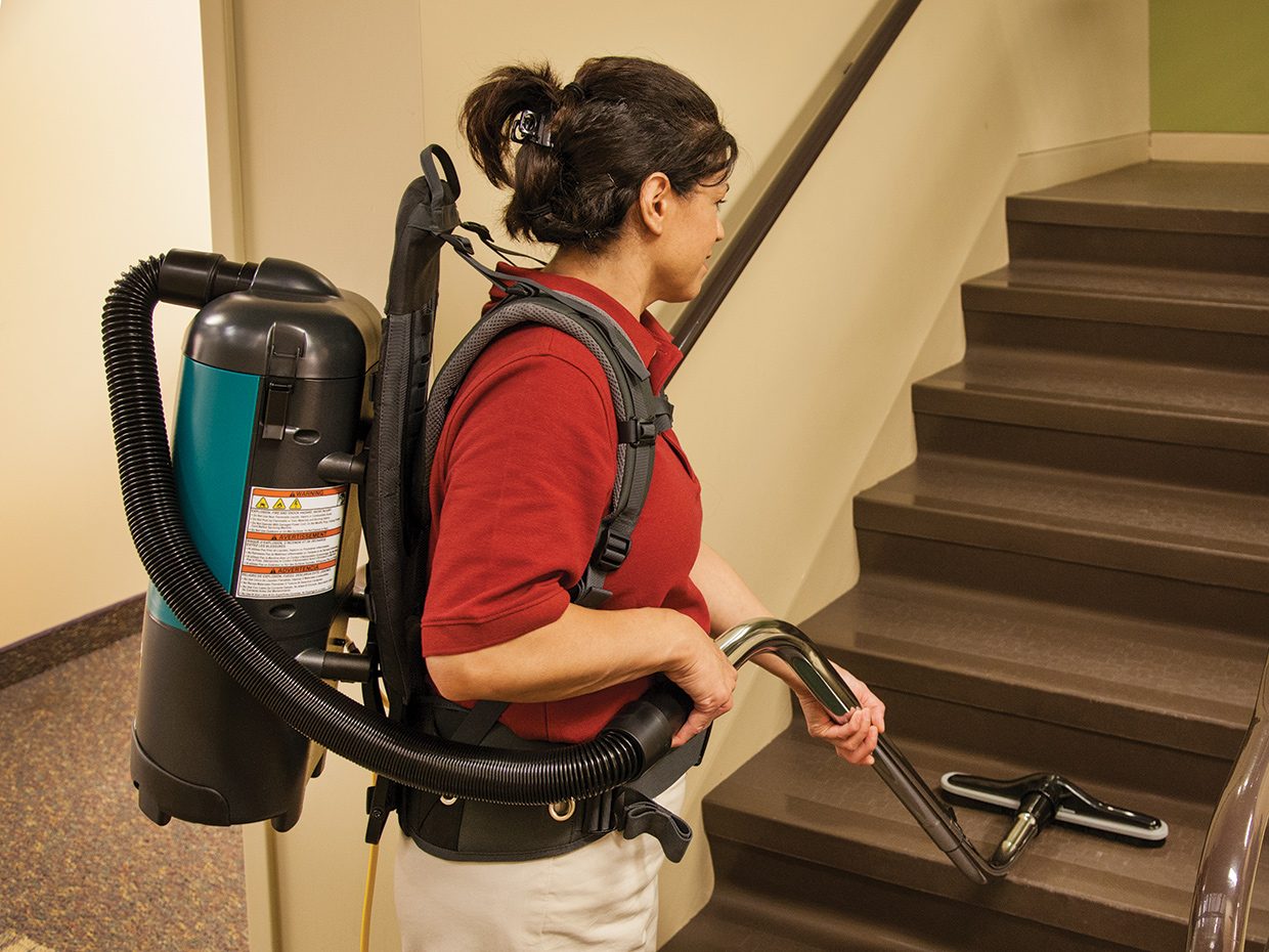 Backpack Vacuum in Use Cleaning Stairs Backpack Vacuum in Use Cleaning Stairs