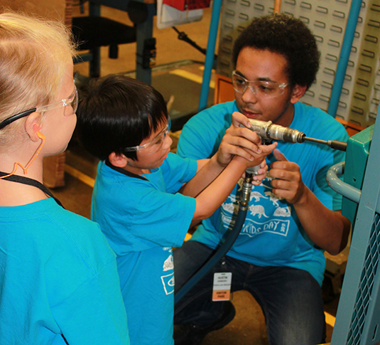 Child helping weld at Tennant Kids Day Child helping weld at Tennant Kids Day