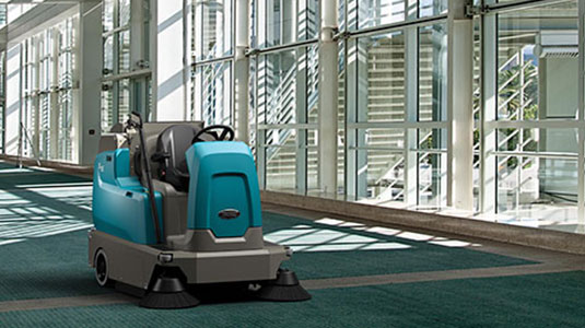 Tennant's new S16 ride-on carpet sweeper cleaning a convention center Tennant's new S16 ride-on carpet sweeper cleaning a convention center