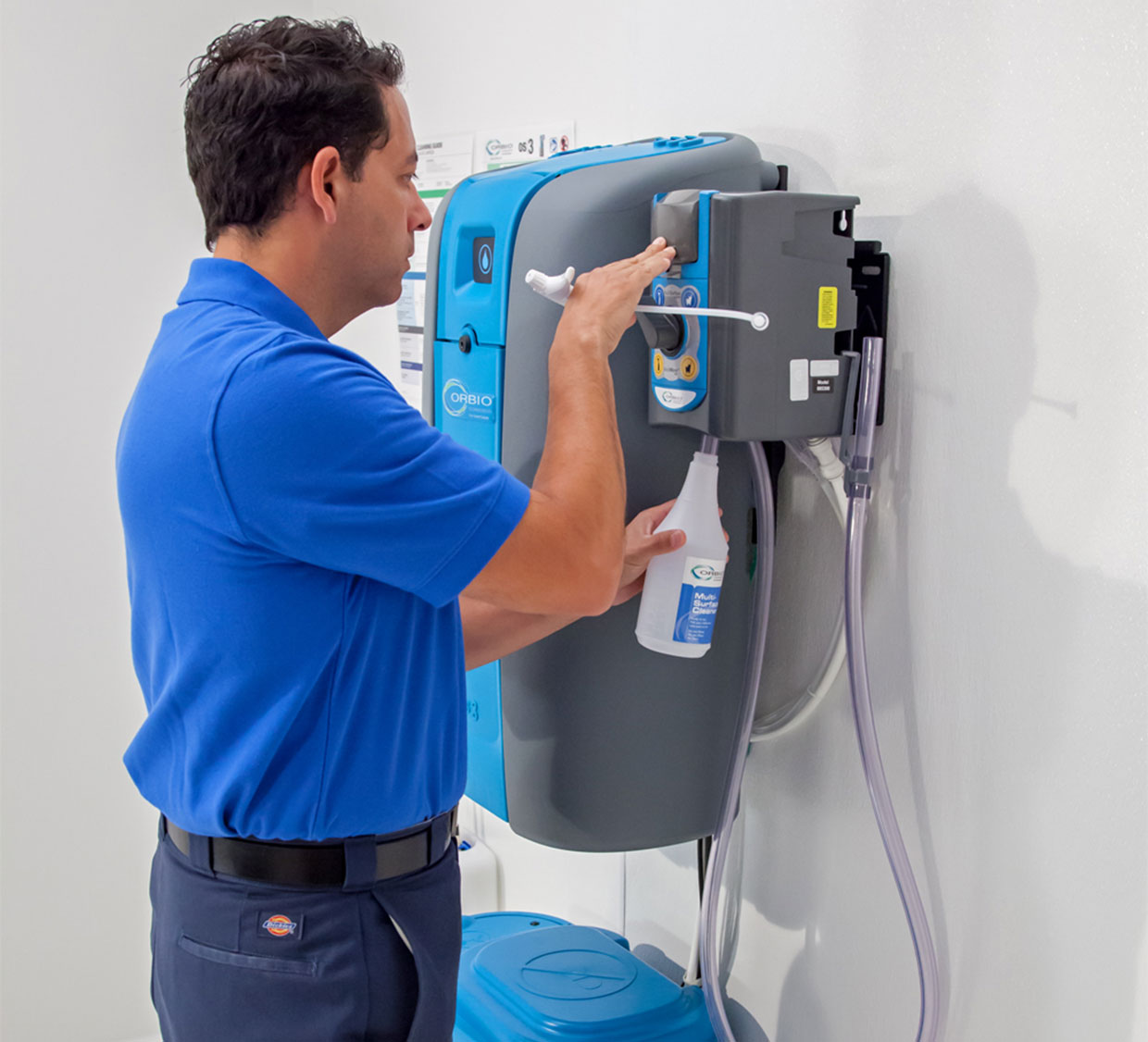 A worker fills a spray bottle with cleaning solution generated on site by the Orbio os3 system. A worker fills a spray bottle with cleaning solution generated on site by the Orbio os3 system.