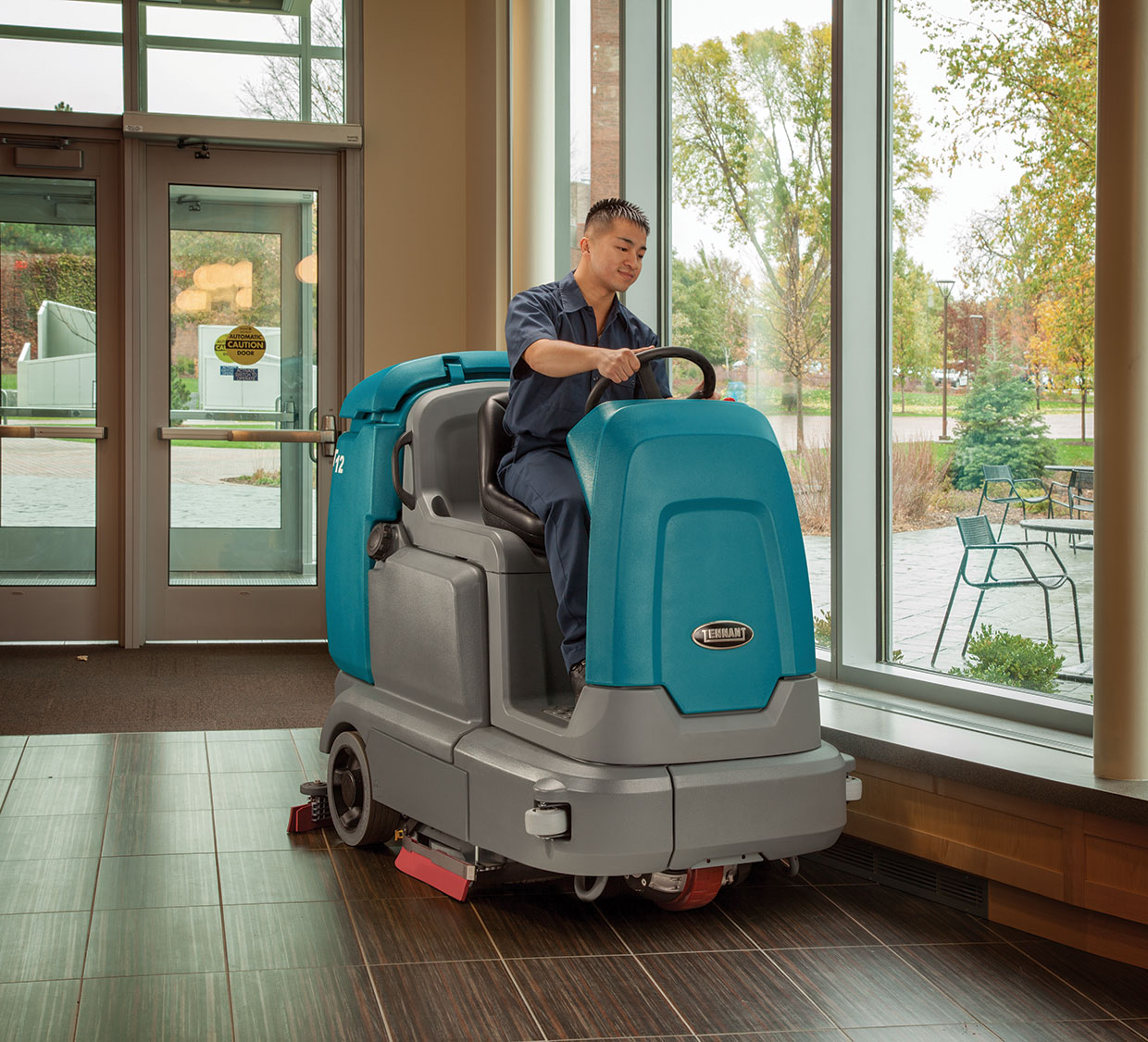 A T12 scrubber cleans a building lobby A T12 scrubber cleans a building lobby