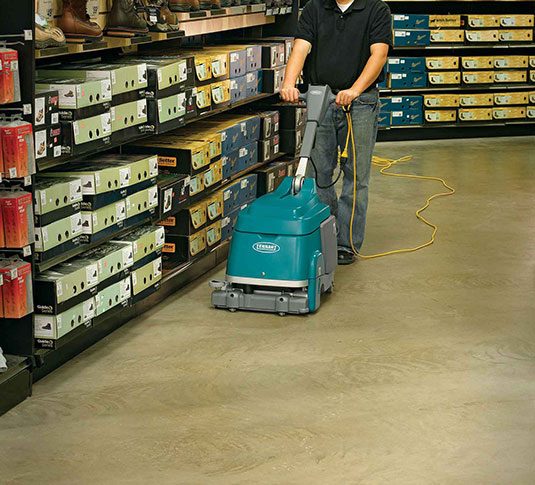 Tennant T1 scrubber cleaning floor