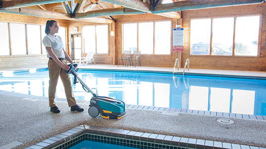 CS5 Walk-Behind Floor Scrubber cleaning near a pool CS5 Walk-Behind Floor Scrubber cleaning near a pool