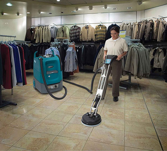 cleaning crew cleaning tile in clothing department store using Tennant Q12 multi-surface cleaning machine cleaning crew cleaning tile in clothing department store using Tennant Q12 multi-surface cleaning machine