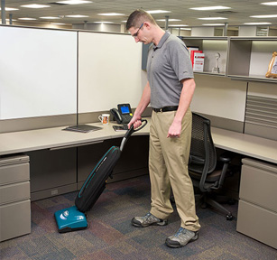 cleaning crew using tennant upright vacuum to clean office cubicle cleaning crew using tennant upright vacuum to clean office cubicle