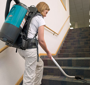 custodial staff using tennant backpack vacuum to clean office building carpeted stairs custodial staff using tennant backpack vacuum to clean office building carpeted stairs