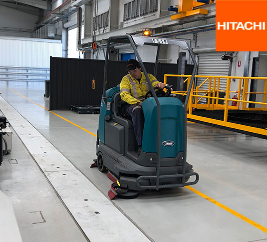 Tennant T12 Ride-On Scrubber cleaning a manufacturing facility Tennant T12 Ride-On Scrubber cleaning a manufacturing facility